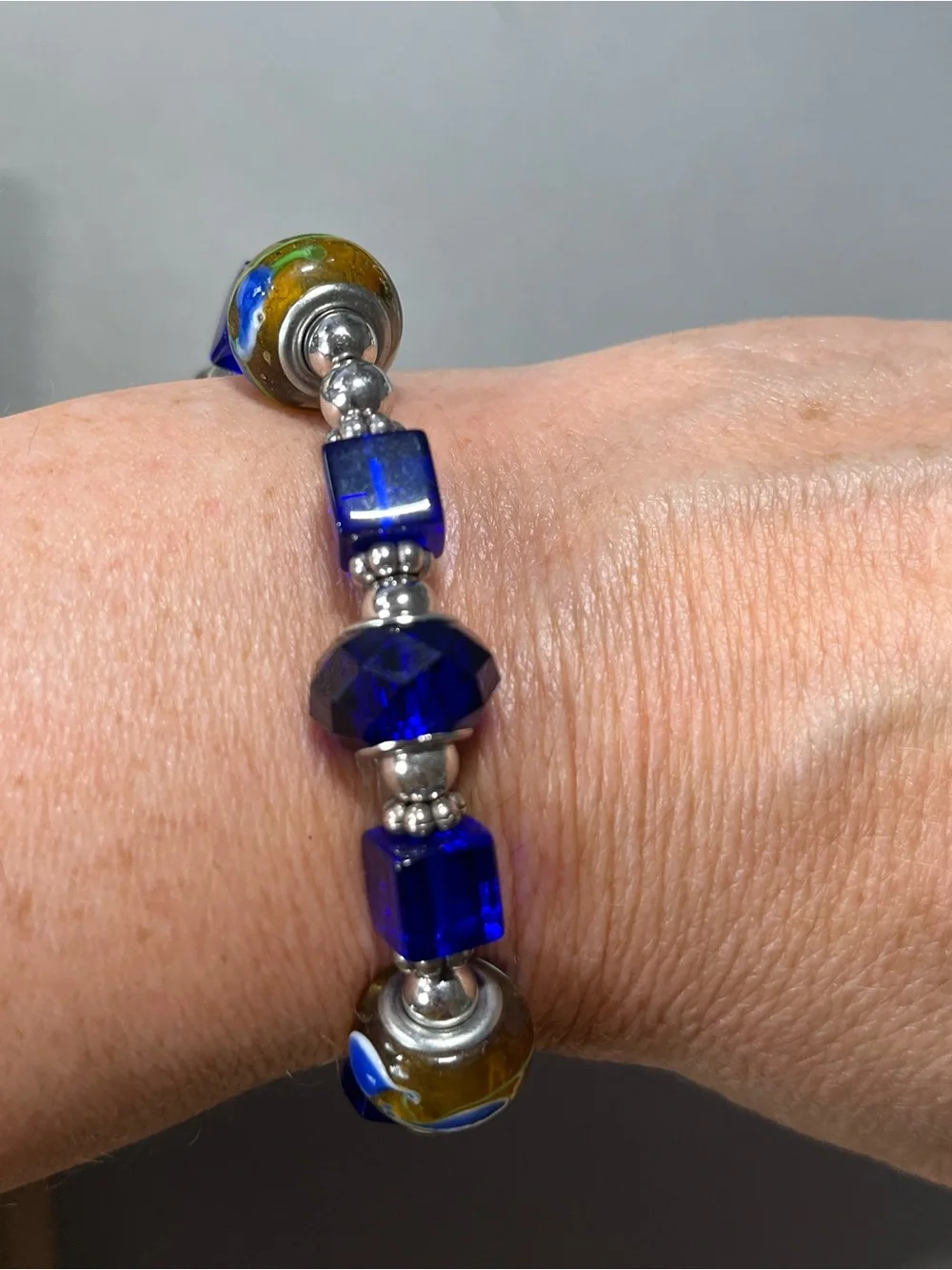 NWOT beautiful blue and yellow plastic beads with silver tone beads in between.